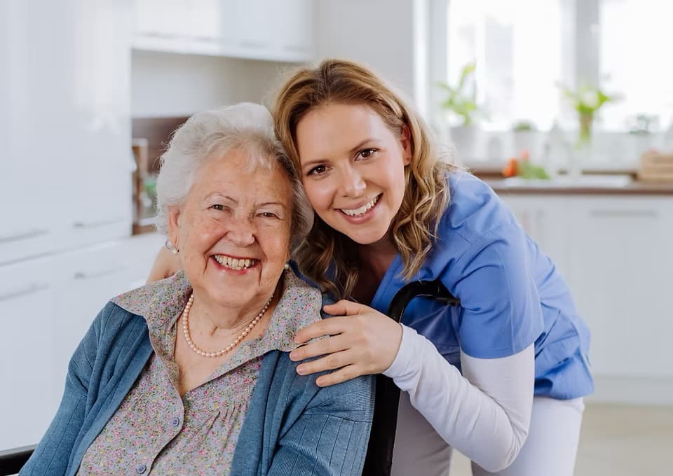 Caregiver supporting a smiling senior at home
